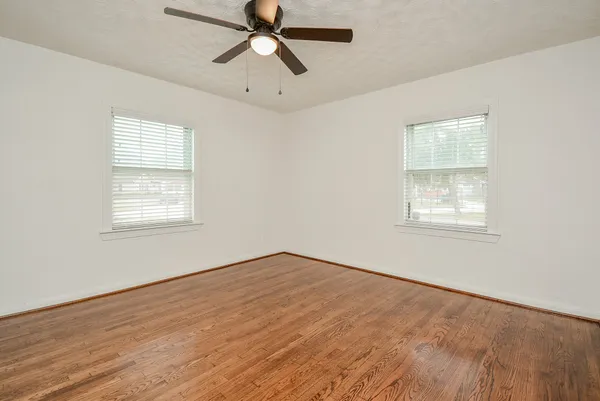 wooden floor in an empty room with a window