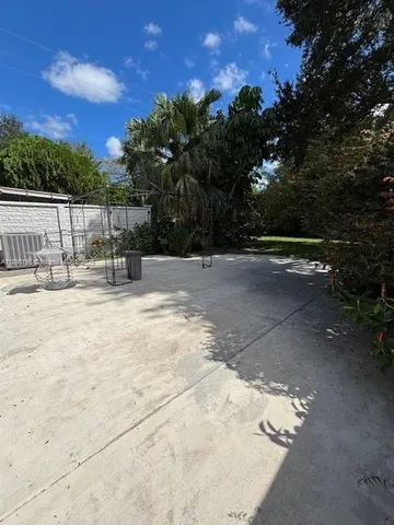 a backyard of a house with table and chairs