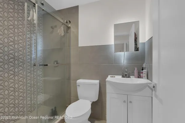 a bathroom with a sink a toilet and a shower