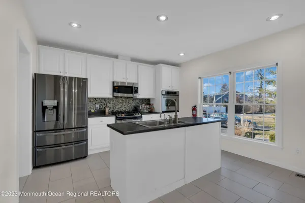 a kitchen with a sink stainless steel appliances and cabinets