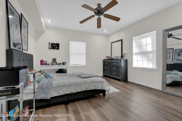 a bedroom that has a bed window and a flat screen tv