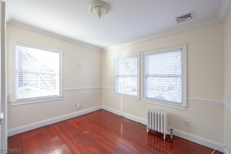 16 Columbus Avenue Glen Ridge, NJ 07028 - Photo 7 of 14 an empty room with wooden floor and windows