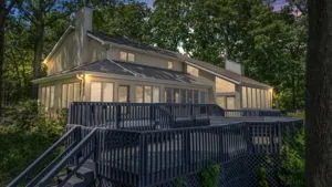 a view of a house with backyard and deck