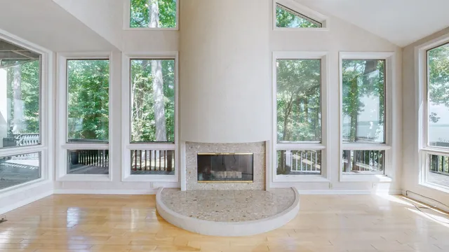 a large white kitchen with a large window and stainless steel appliances