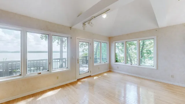a bathroom with a toilet and a mirror