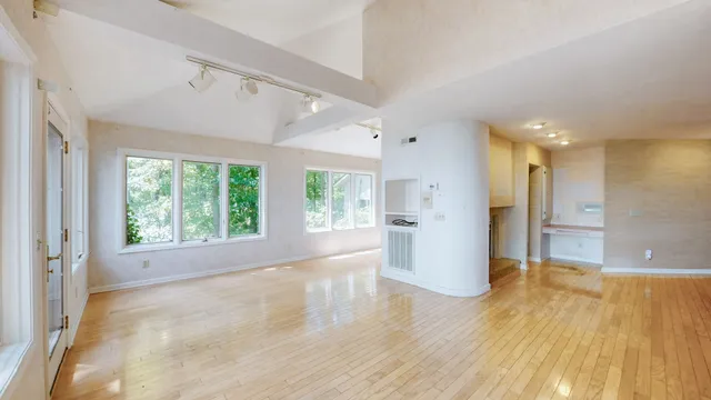 an empty room with windows and closet