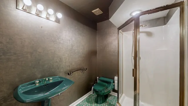 a view of an empty room with brick wall and stairs