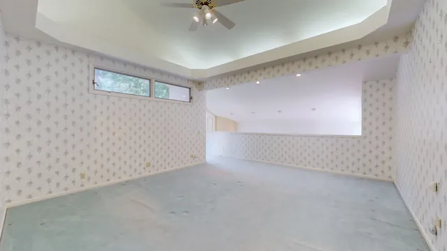 a bathroom with a granite countertop double vanity sink mirror and toilet