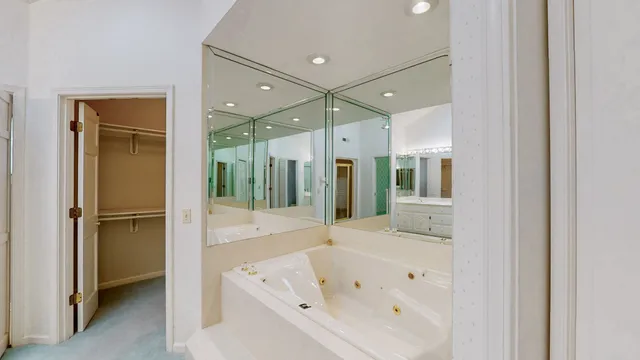 an empty room with window and ceiling fan