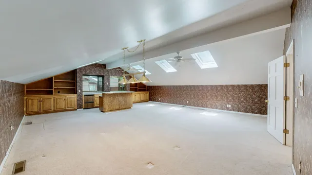 a view of a house with large trees and a barn