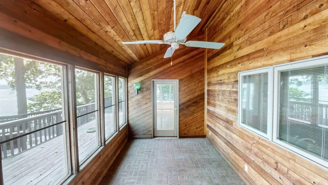 a view of a house with brick walls and flower plants