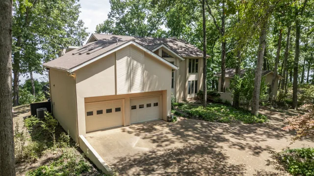an aerial view of a houses with a lake view