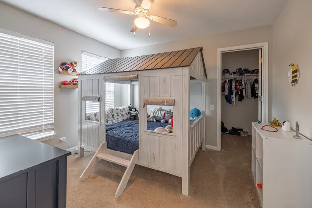 a view of a hallway with workspace and a window