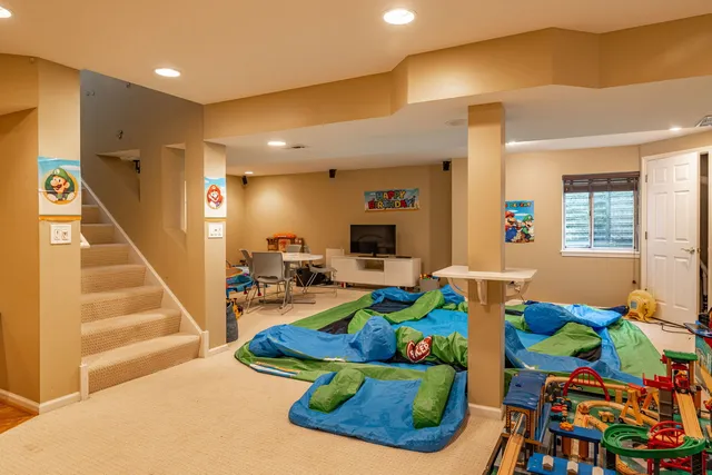 a living room with furniture and a dining table