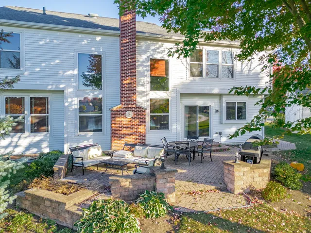 a view of a patio with couches table and chairs potted plants and palm tree