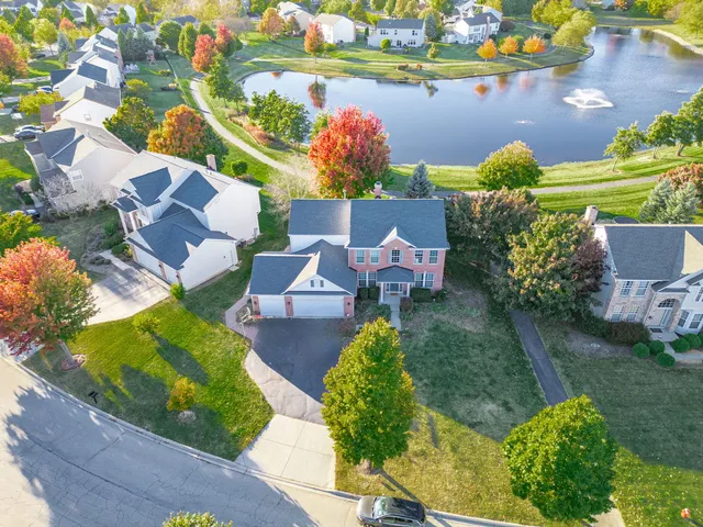 an aerial view of a house with yard swimming pool and outdoor seating