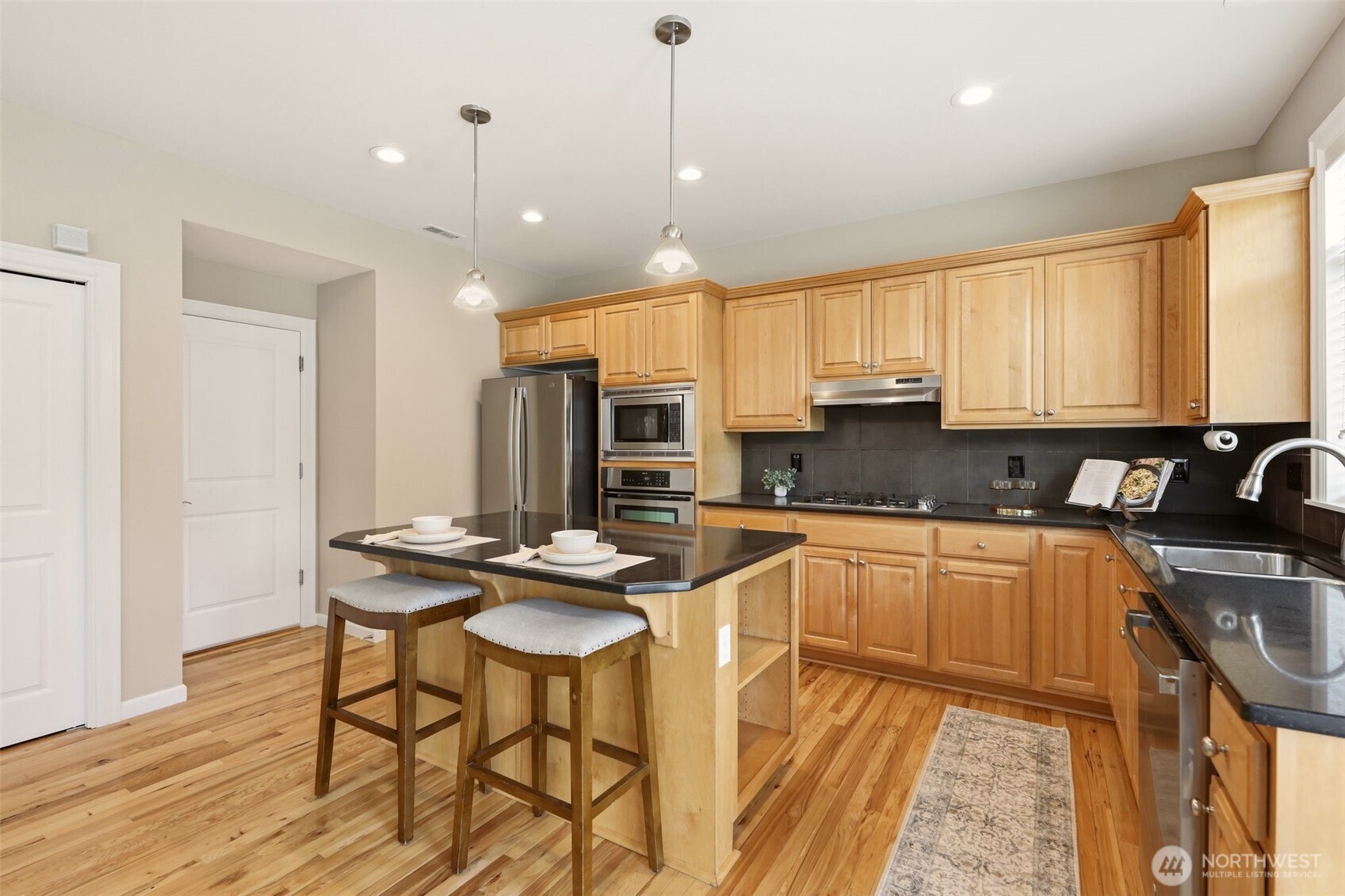 3501 156th Place Southeast Bothell, WA 98012 - Photo 12 of 36 a kitchen with stainless steel appliances kitchen island granite countertop a sink and cabinets