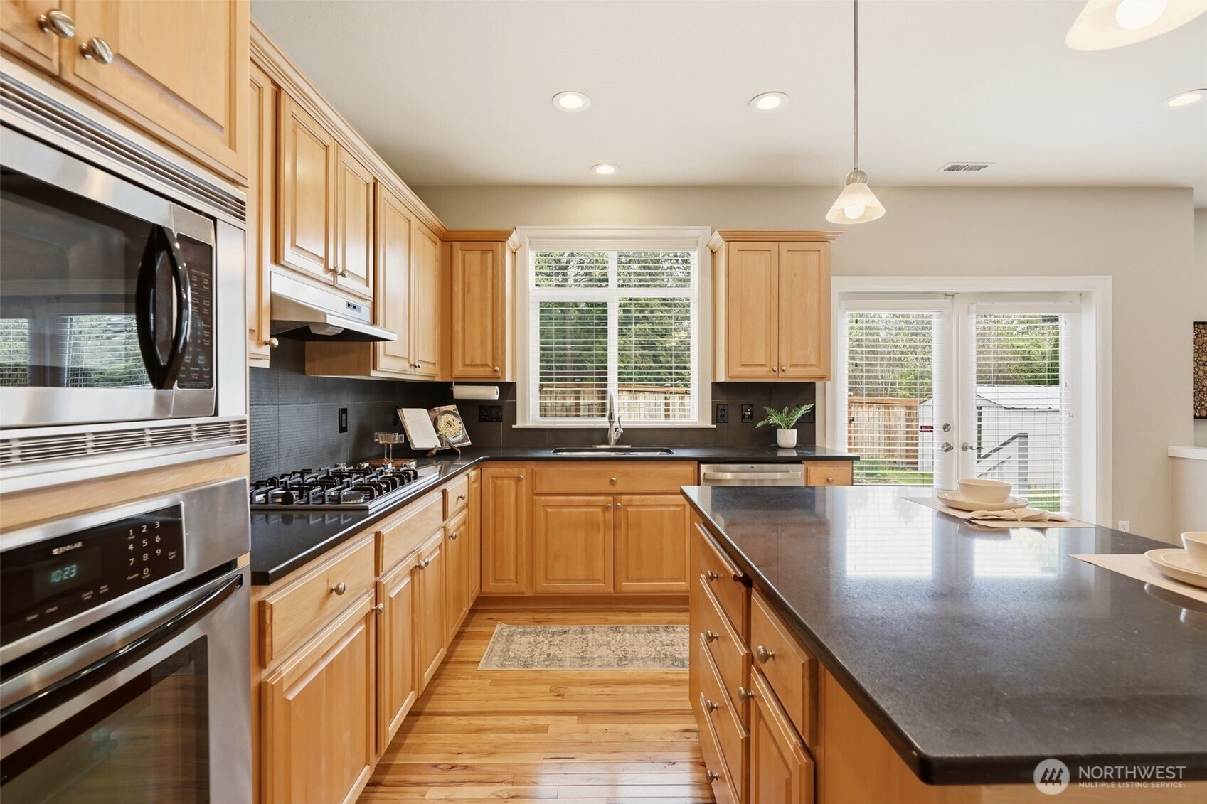3501 156th Place Southeast Bothell, WA 98012 - Photo 14 of 36 a kitchen with stainless steel appliances granite countertop a stove a sink and a microwave