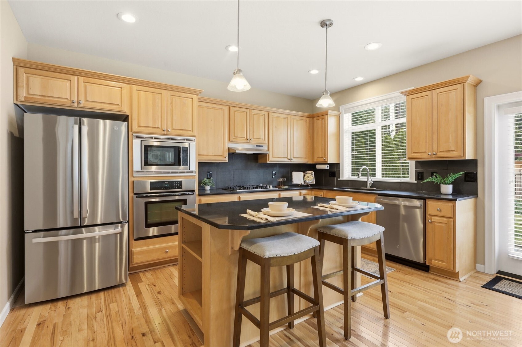 3501 156th Place Southeast Bothell, WA 98012 - Photo 16 of 36 a kitchen with wooden cabinets and stainless steel appliances