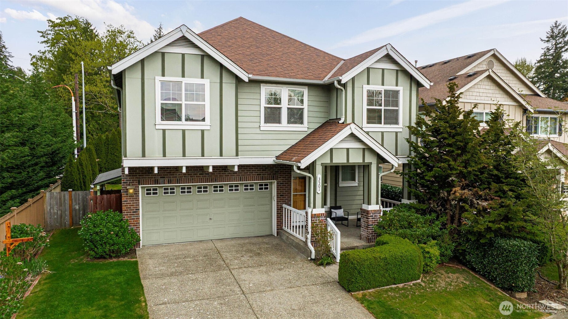 3501 156th Place Southeast Bothell, WA 98012 - Photo 2 of 36 a front view of a house with a yard garage and outdoor seating