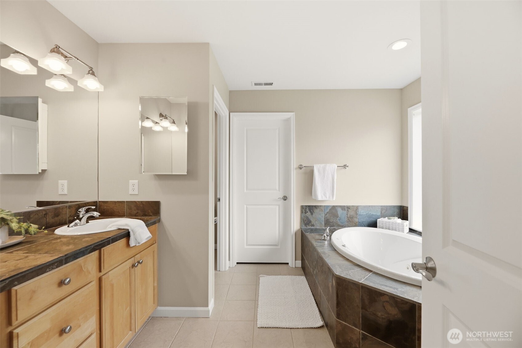 3501 156th Place Southeast Bothell, WA 98012 - Photo 21 of 36 a en suite bathroom with a granite countertop sink and a mirror