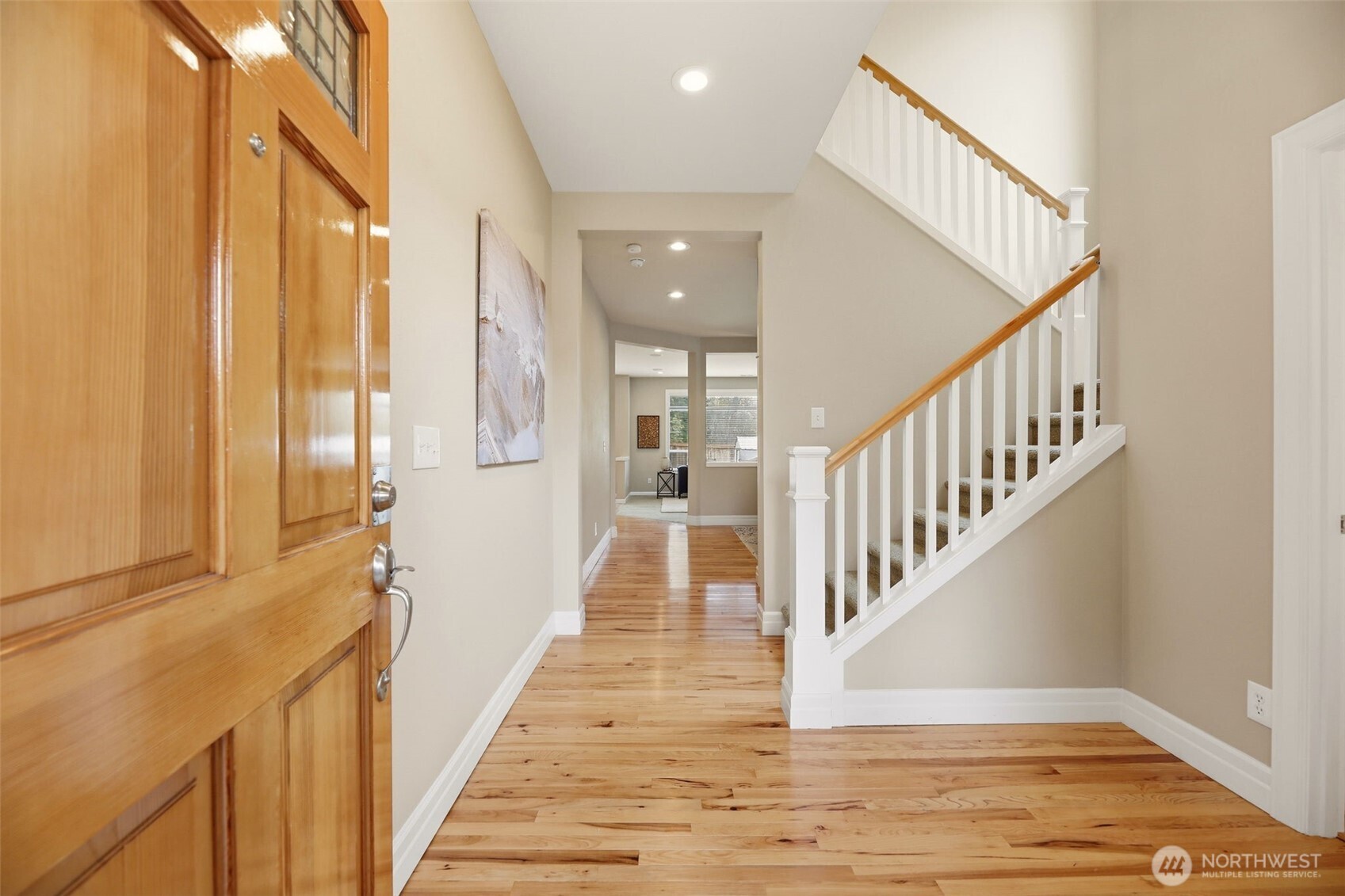 3501 156th Place Southeast Bothell, WA 98012 - Photo 5 of 36 a view of staircase with lots of frames on wall and wooden floor