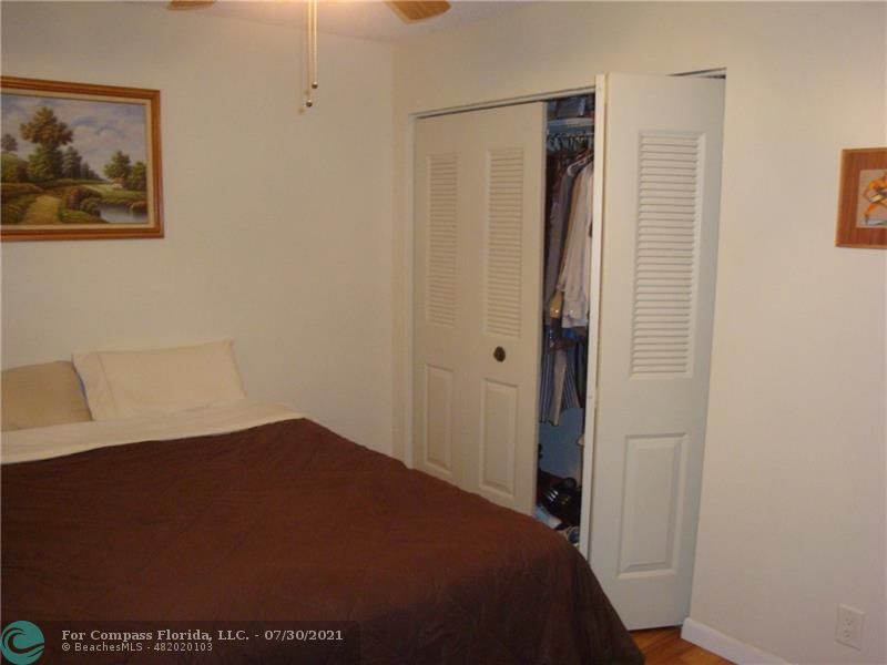 Coral Gate Margate, FL 33063 - Photo 11 of 28 a bedroom with a bed and a painting on the wall