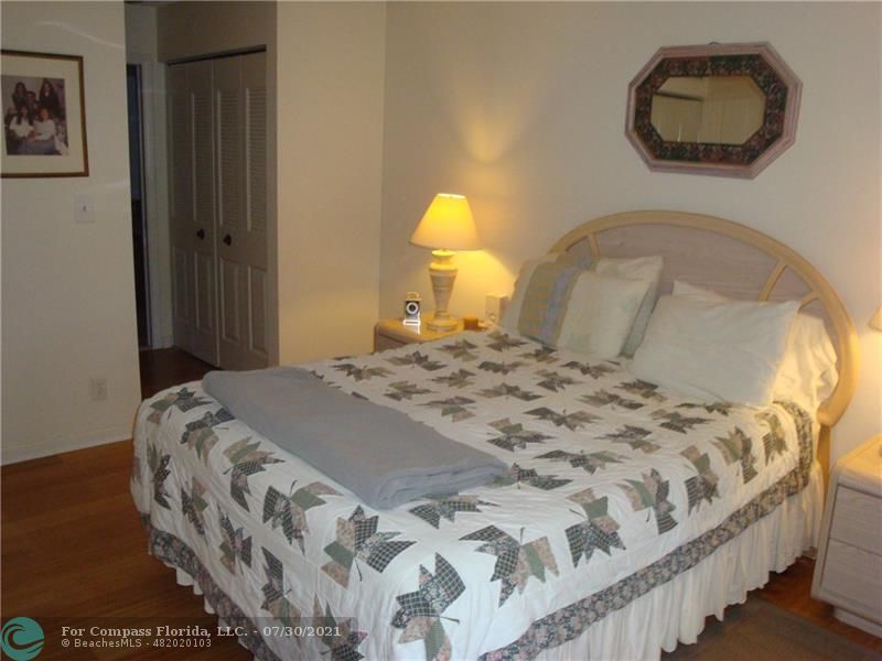 Coral Gate Margate, FL 33063 - Photo 13 of 28 a bedroom with a bed and a painting on the wall