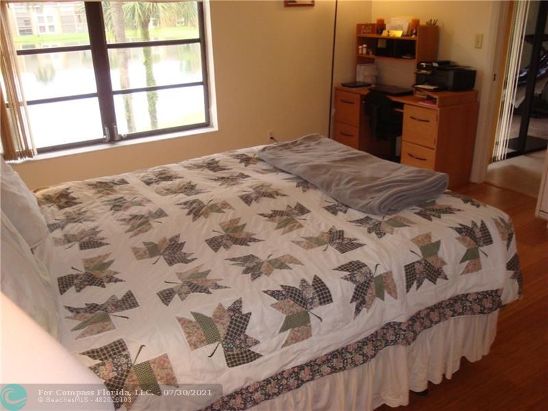 Coral Gate Margate, FL 33063 - Photo 14 of 28 a bedroom with a bed and wooden floor