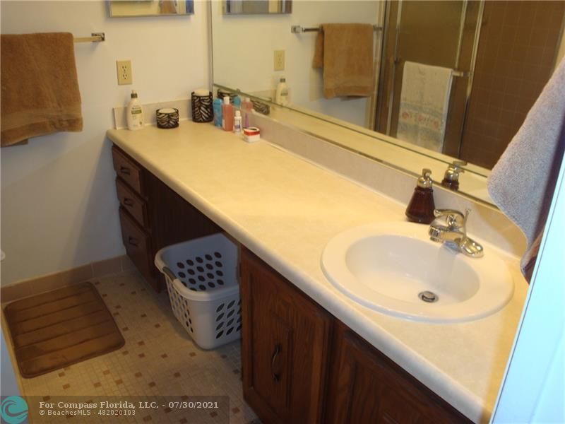 Coral Gate Margate, FL 33063 - Photo 17 of 28 a bathroom with a sink and a mirror