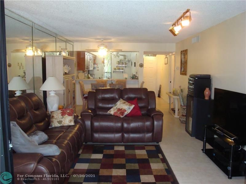 Coral Gate Margate, FL 33063 - Photo 22 of 28 a living room with furniture and a flat screen tv