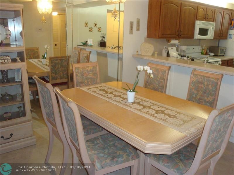 Coral Gate Margate, FL 33063 - Photo 24 of 28 a kitchen with stainless steel appliances granite countertop a sink a stove a dining table and chairs