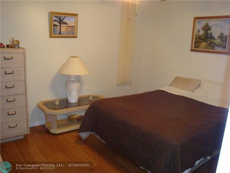 Coral Gate Margate, FL 33063 - Photo 9 of 28 a bedroom with a bed and a lamp on dresser