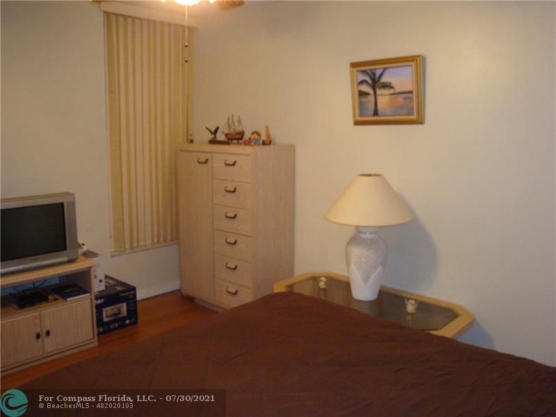Coral Gate Margate, FL 33063 - Photo 10 of 28 a room with a cabinet and flat screen tv