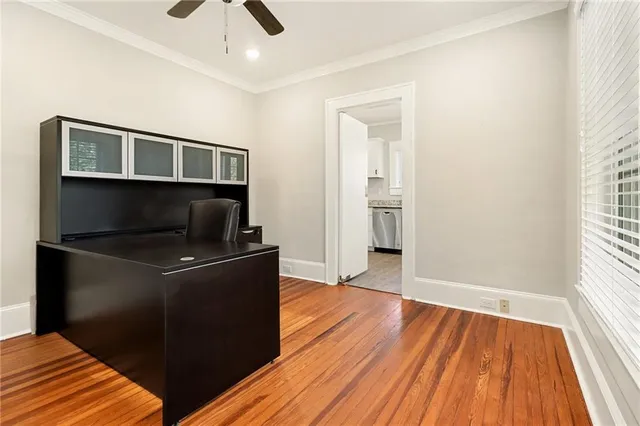 a living room with wooden floor and ceiling fan