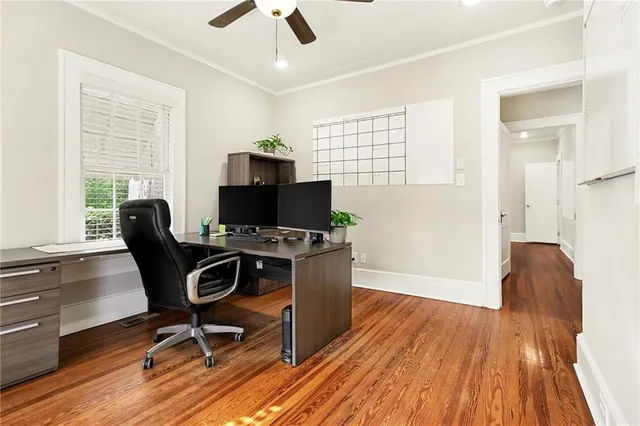 a view of a workspace with furniture and a window