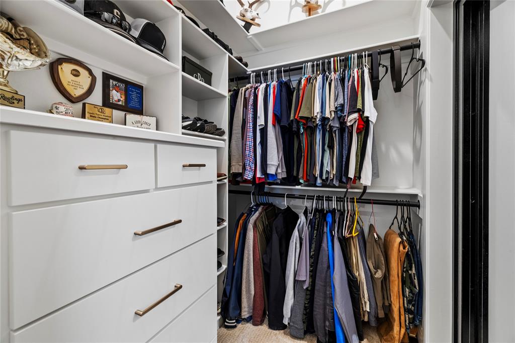 2804 Buchanan Road Hallsville, TX 75650 - Photo 19 of 40 a view of walk in closet with clothes and shoes