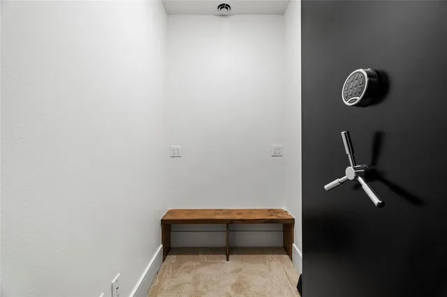 a room with a wooden floor and a wall painting