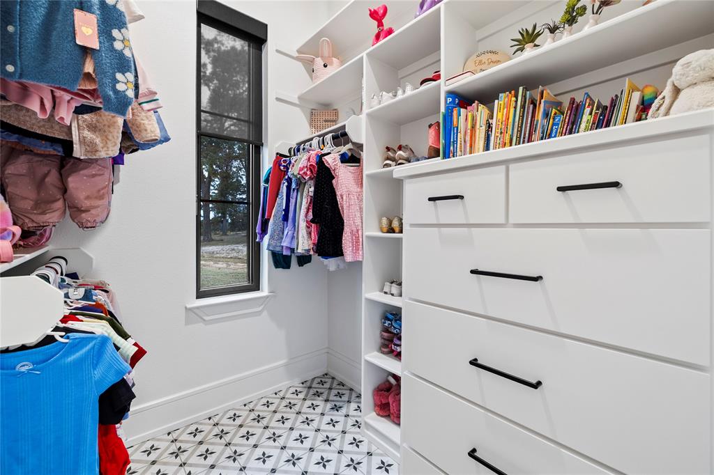 2804 Buchanan Road Hallsville, TX 75650 - Photo 24 of 40 a view of walk in closet with clothes and shoes