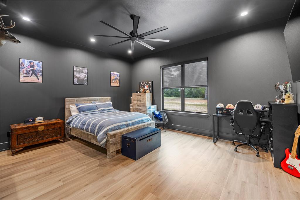 2804 Buchanan Road Hallsville, TX 75650 - Photo 29 of 40 a bedroom with a bed and a chandelier