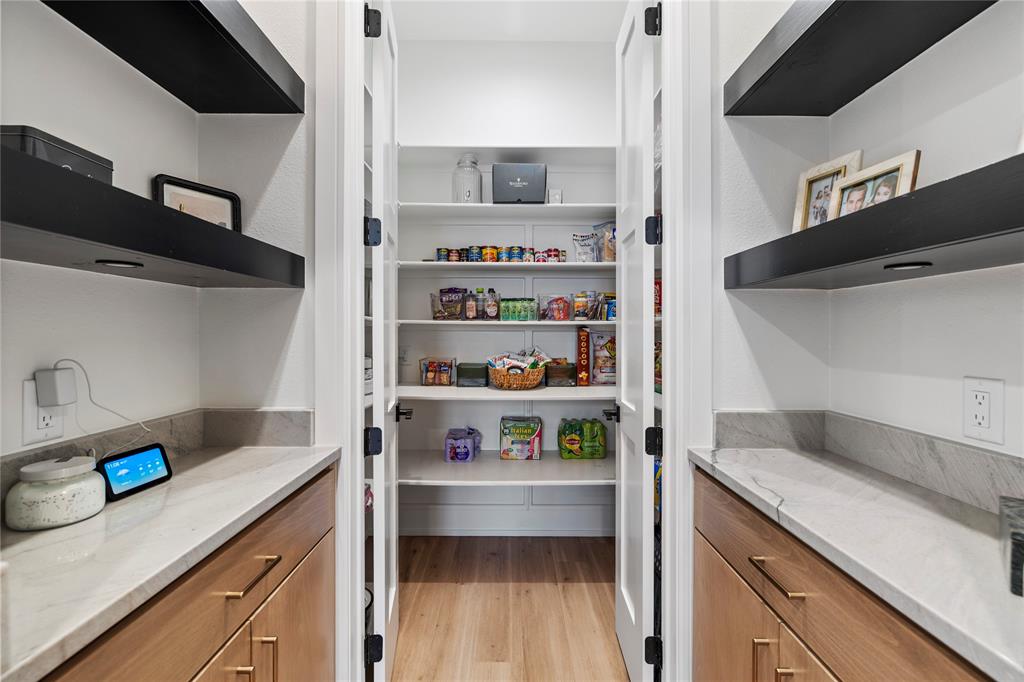 2804 Buchanan Road Hallsville, TX 75650 - Photo 10 of 40 a kitchen with white cabinets and a wooden floor