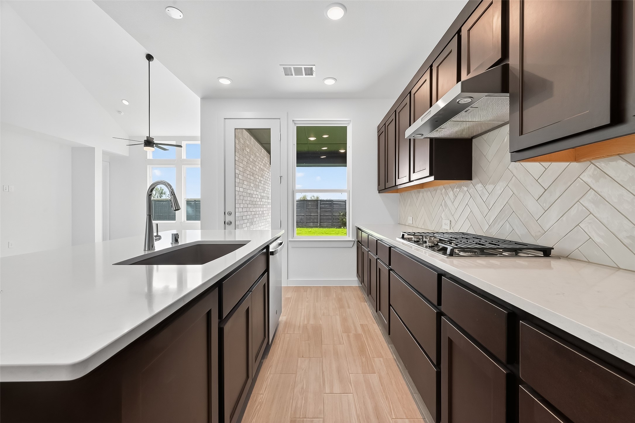 3222 Kindred Way Richmond, TX 77406 - Photo 17 of 50 a kitchen with stainless steel appliances granite countertop a sink stove and cabinets