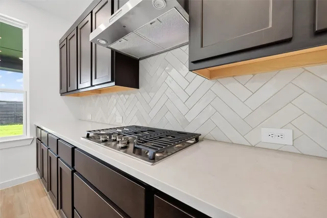 a kitchen with cabinets and a stove top oven