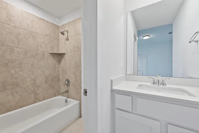a bathroom with a tub a sink and mirror