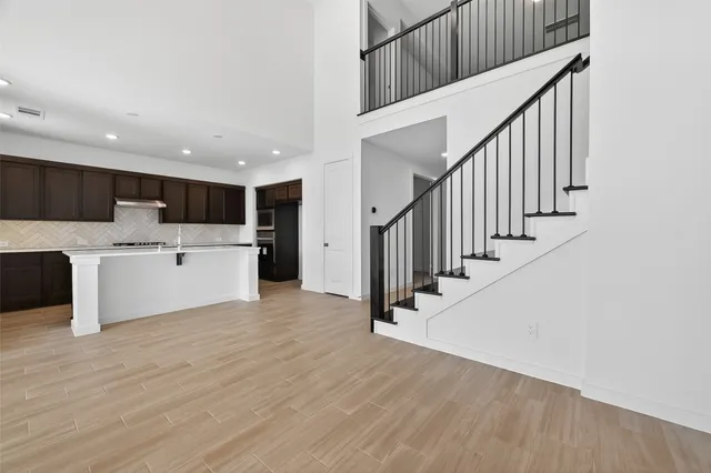 a view of a kitchen with wooden floor and electronic appliances