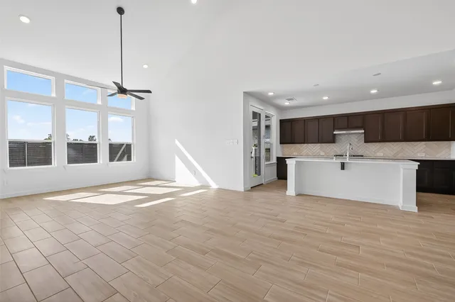 a view of a kitchen with a sink and white cabinets