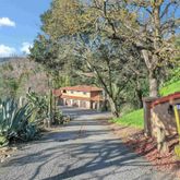 a living room with furniture large window and wooden floor