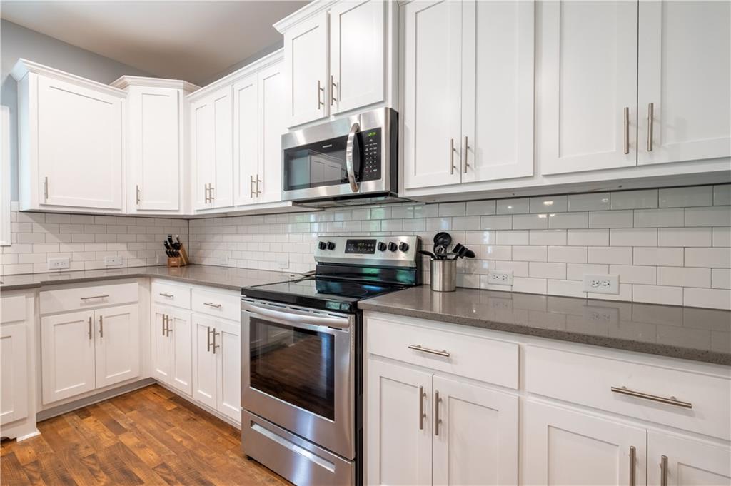 719 Fairview Road Brooks, GA 30205 - Photo 16 of 35 a kitchen with white cabinets and white appliances