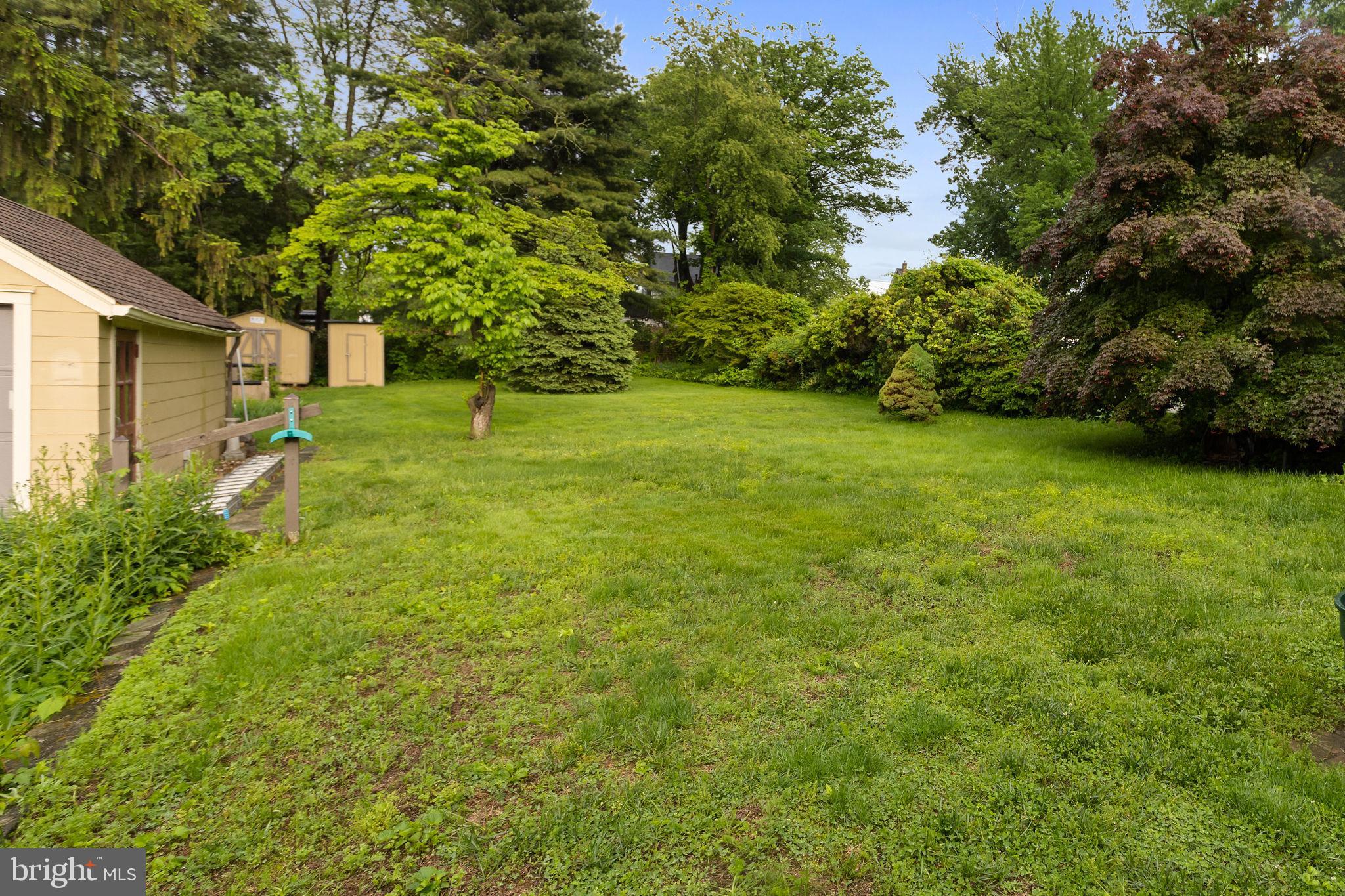 10 Pershing Avenue Ewing, NJ 08618 - Photo 22 of 24 a backyard of a house with plants and large trees