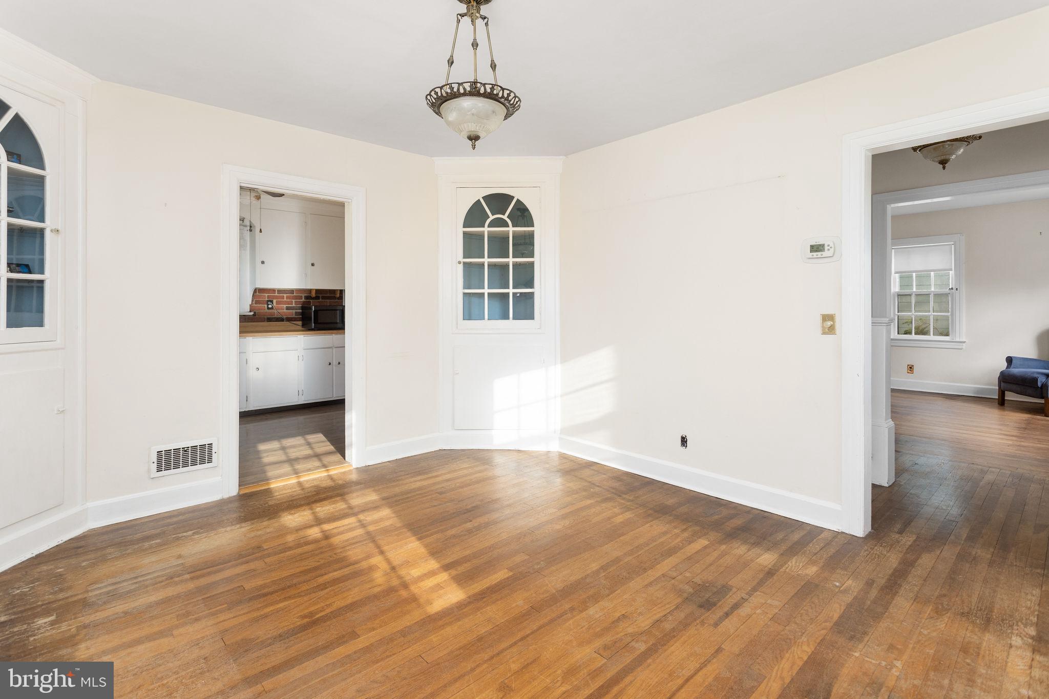 10 Pershing Avenue Ewing, NJ 08618 - Photo 9 of 24 a view of empty room with wooden floor and windows